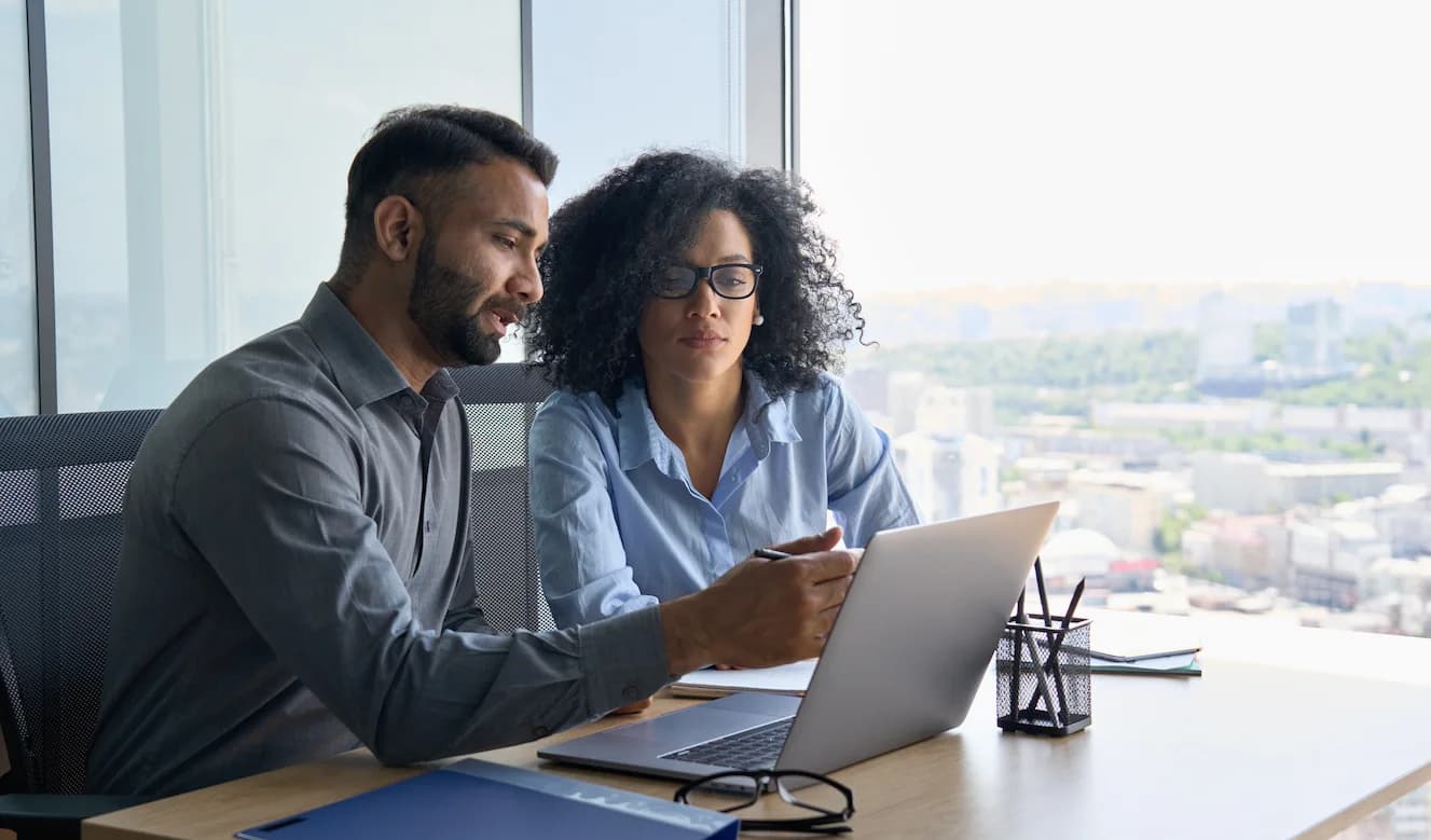 two people looking at computer